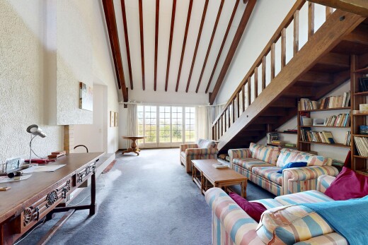 living area with carpet floors and vaulted ceiling