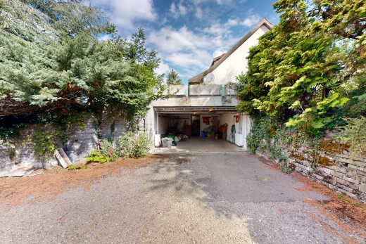 view of home featuring asphalt driveway