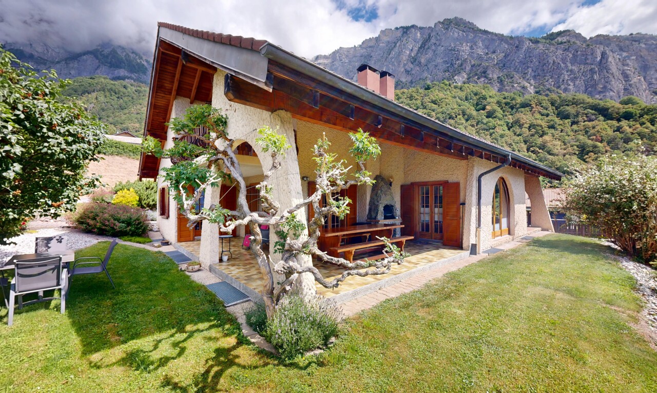 façade avec mountain view, vue sur la montagne, property visible, cheminée, et terrasse