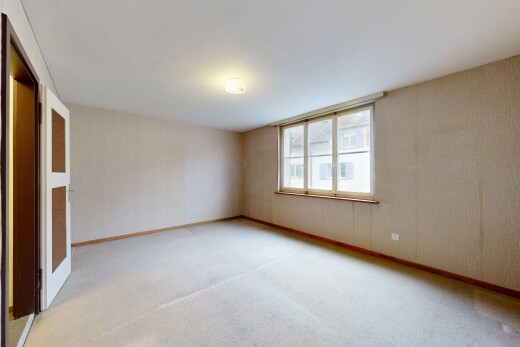 empty room featuring light carpet and baseboards