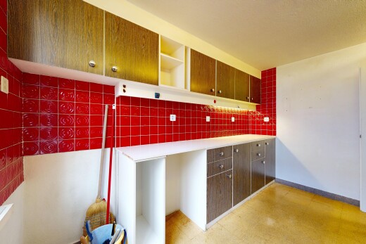 kitchen with open shelves, light countertops, backsplash, and light flooring