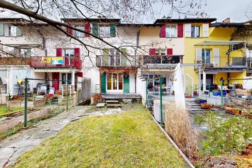 outdoor house featuring a balcony, a patio area, and stucco siding