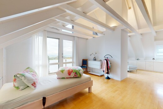 zimmer / schlafzimmer mit high end ceiling, wood finish floor, holzfußboden, inside property, und natürliches licht