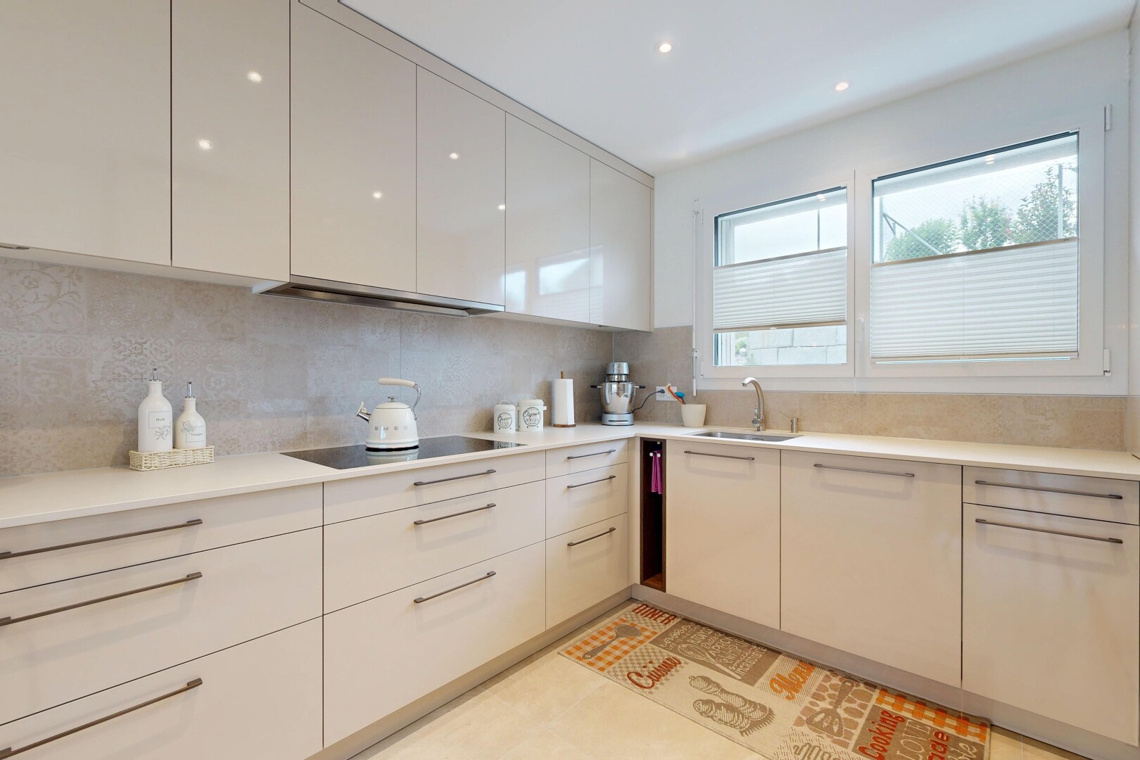 küche mit light countertops, light floor, flat panel cabinets, schränke mit flachen paneelen, und natural light