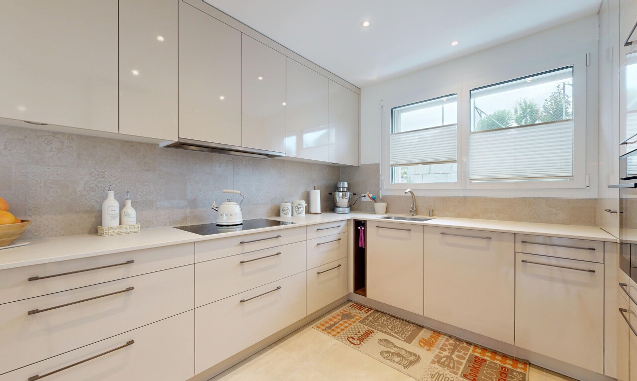 küche mit light countertops, light floor, flat panel cabinets, schränke mit flachen paneelen, und natural light
