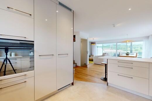 kitchen with modern cabinets, light countertops, and white cabinets