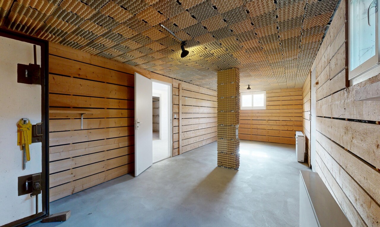 rezeption / lobby mit wood wall, concrete floor, natural light, inside property, und finished concrete floor