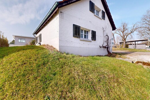 façade avec day time, pelouse, property visible, et bardage en stuc