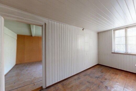 empty room featuring hardwood / wood-style flooring and wooden walls