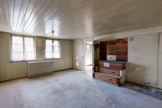 unfurnished room with radiator and carpet floors