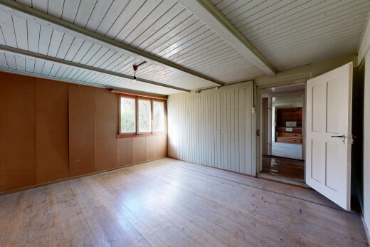unfurnished room featuring light wood-style flooring and beamed ceiling