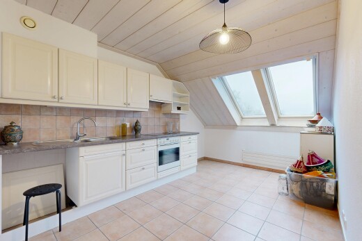 cuisine avec armoires élevées, puits de lumière, dosseret, backsplash, et plafond voûté