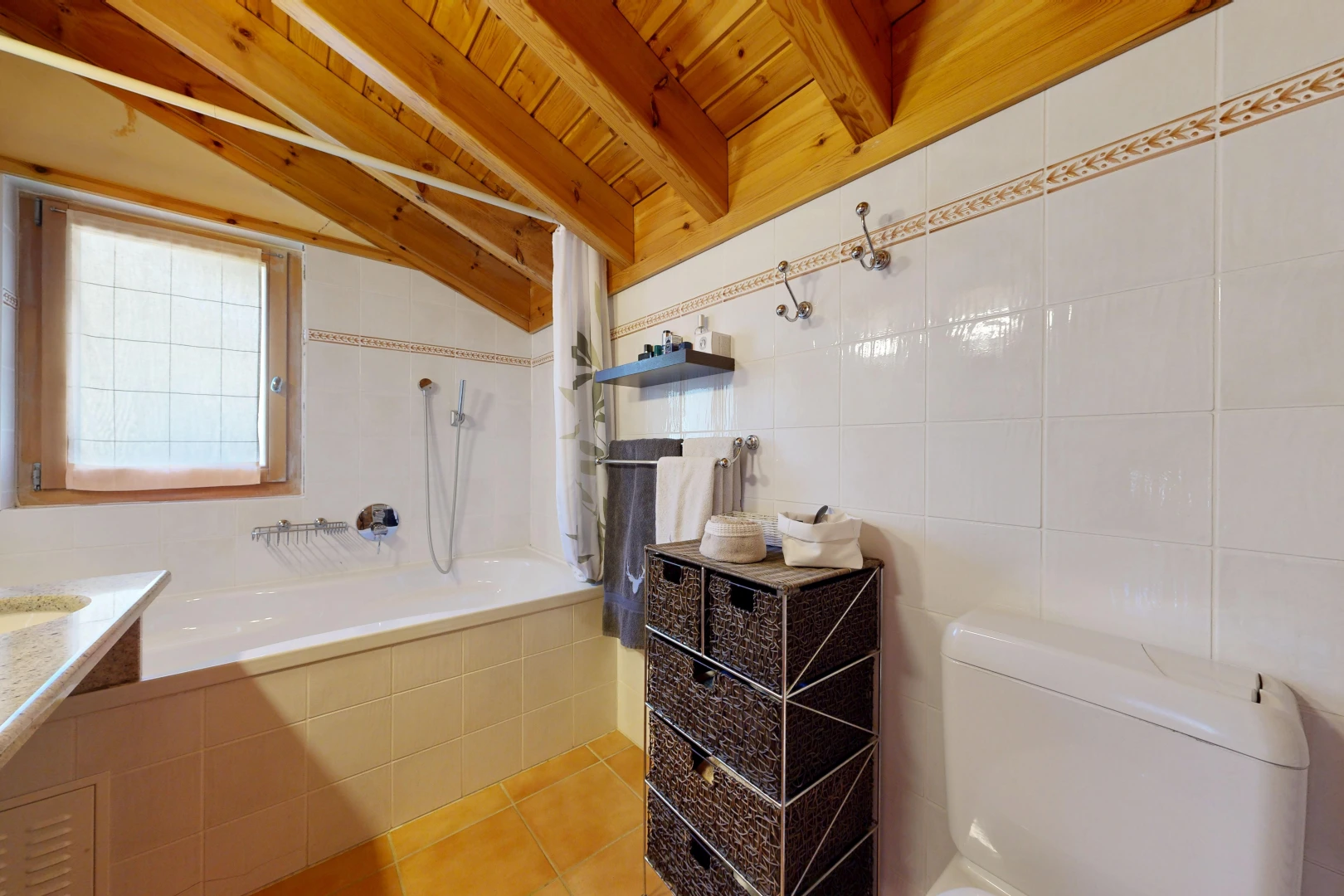 bathroom with tile walls, light tile patterned floors, wooden ceiling, tiled shower / bath, and vaulted ceiling with beams
