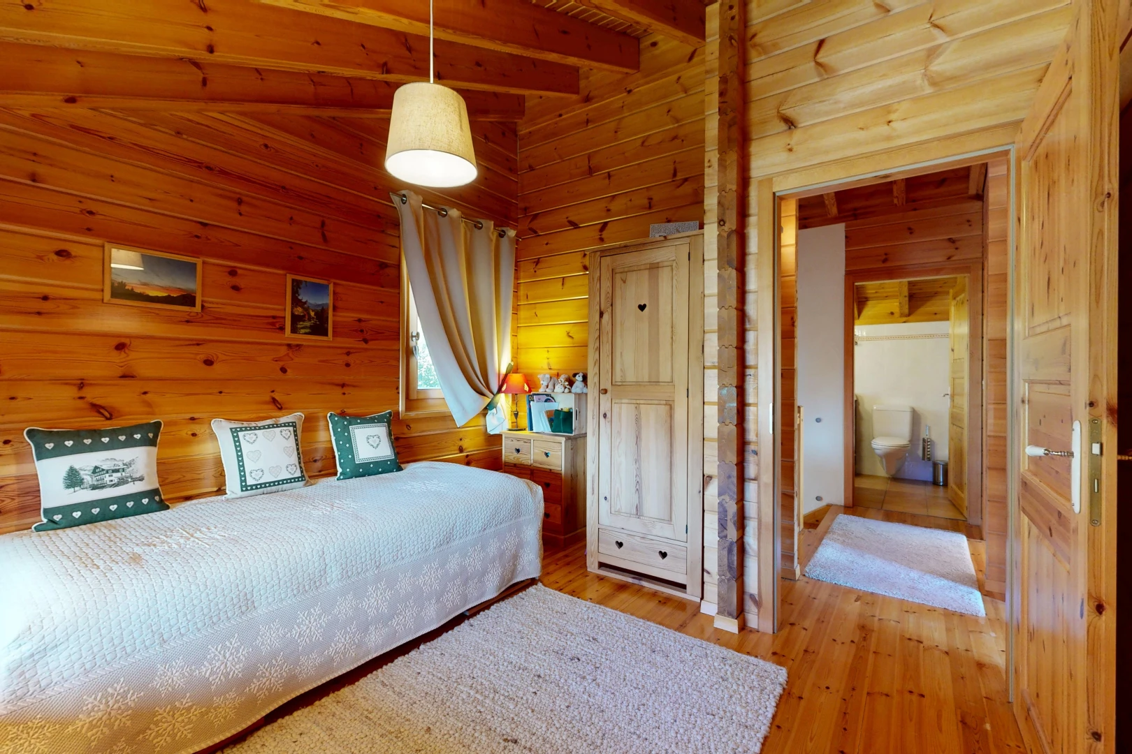 room with wood walls, hanging light fixtures, and light wood-type flooring