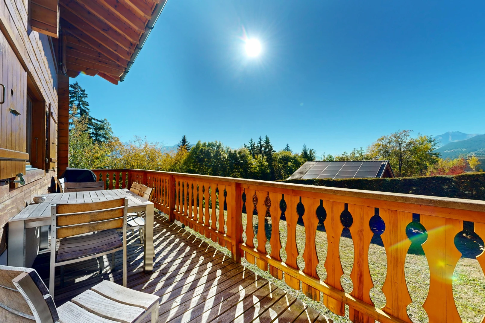 view of wooden balcony with outdoor dining area and a wooden deck