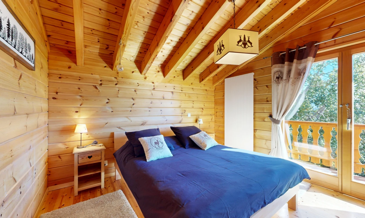 room / bedroom featuring wood ceiling, wood walls, light wood-type flooring, and vaulted ceiling with beams