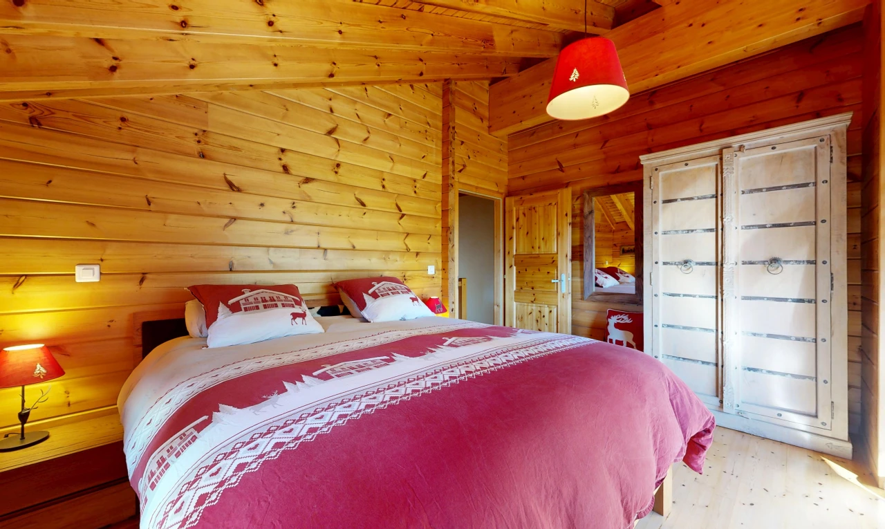 room with wooden ceiling, wooden walls, light wood-type flooring, and vaulted ceiling with beams