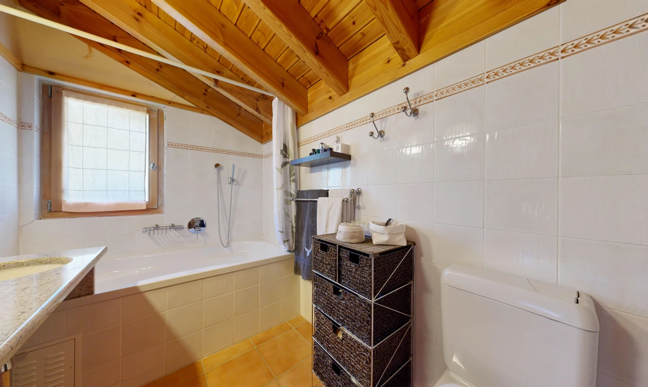 bathroom with tile walls, light tile patterned floors, wooden ceiling, tiled shower / bath, and vaulted ceiling with beams