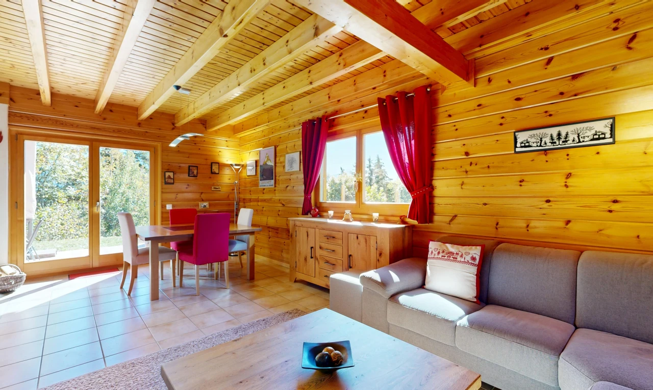 living area featuring a wood ceiling with exposed beams, wooden walls, light tile patterned floors, and access to exterior