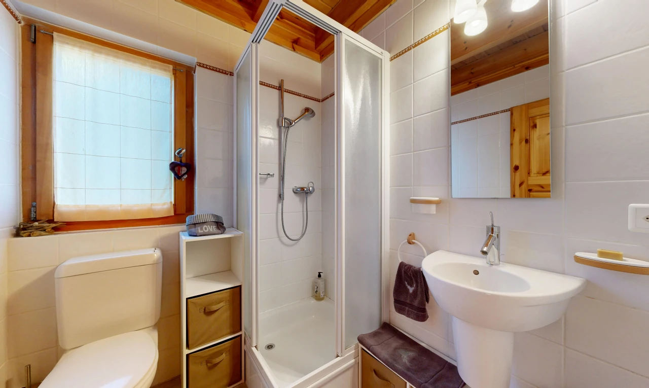 full bath with a shower stall and tile walls