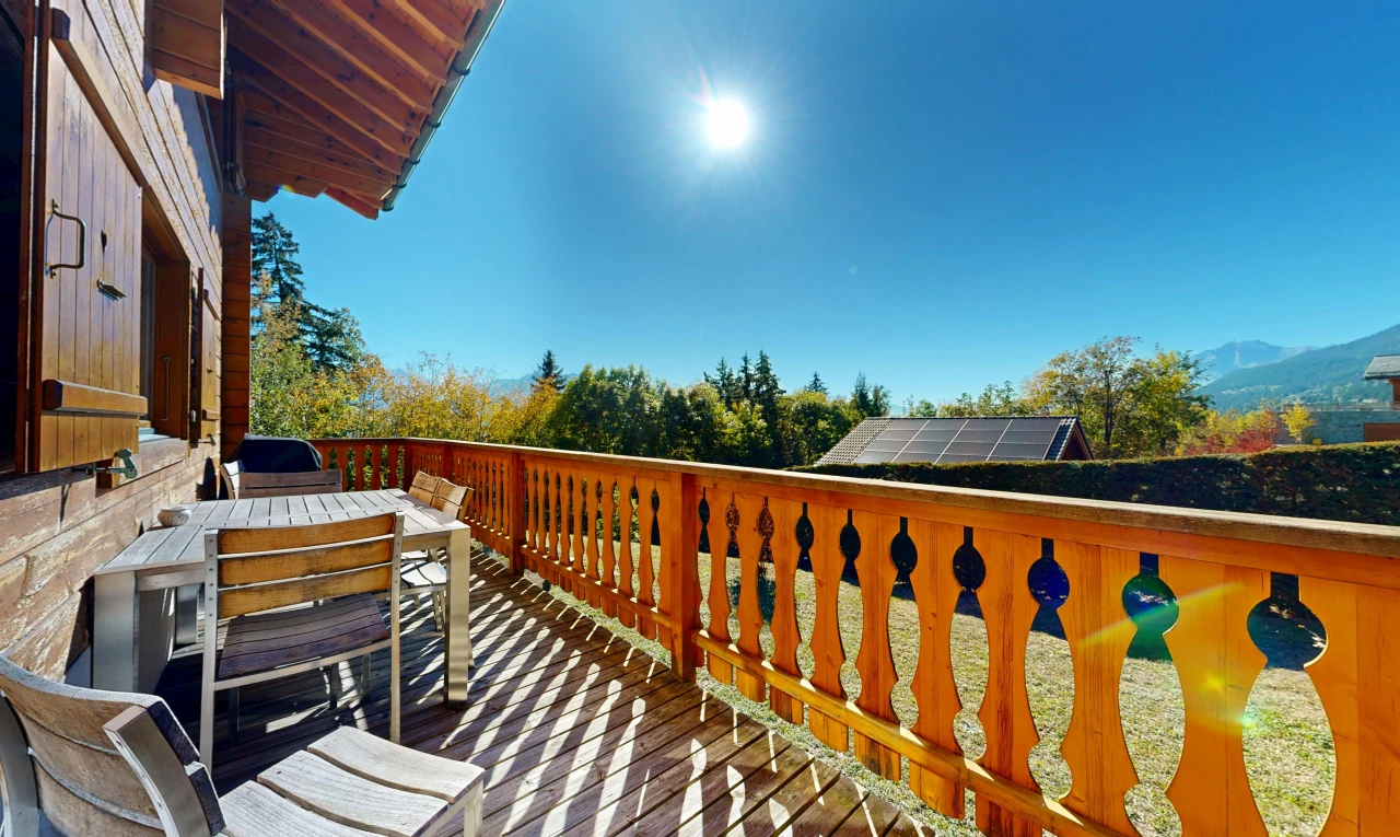 view of wooden balcony with outdoor dining area and a wooden deck