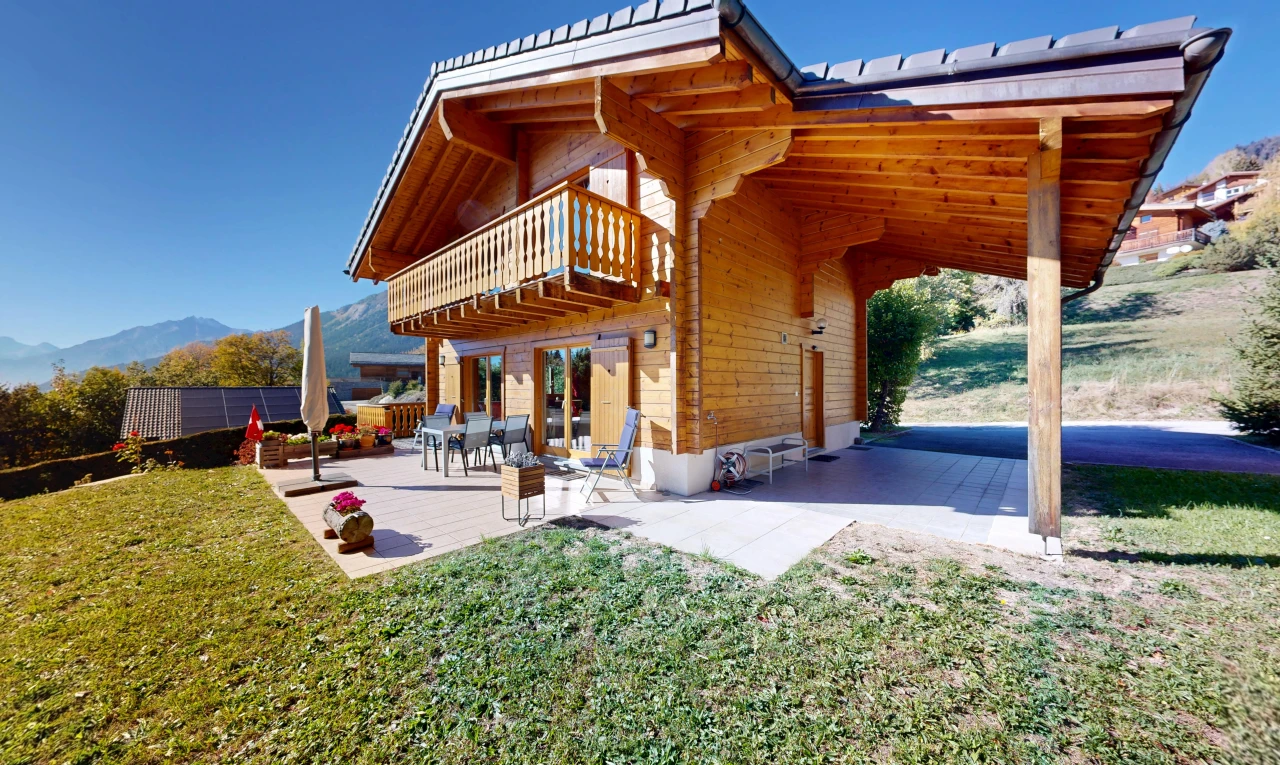 view of home featuring a balcony and a patio