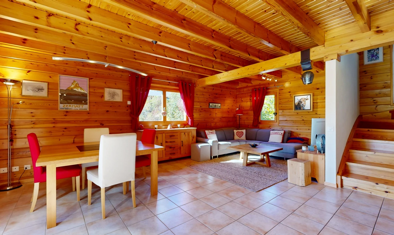living / dining room with a wood ceiling with exposed beams, wooden walls, and light tile patterned floors