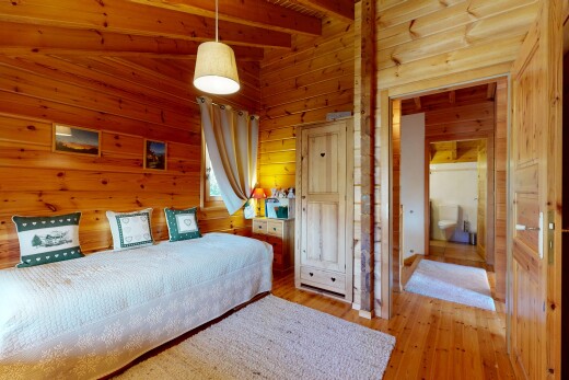 room with wood walls, hanging light fixtures, and light wood-type flooring