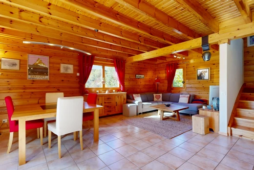 living / dining room with a wood ceiling with exposed beams, wooden walls, and light tile patterned floors