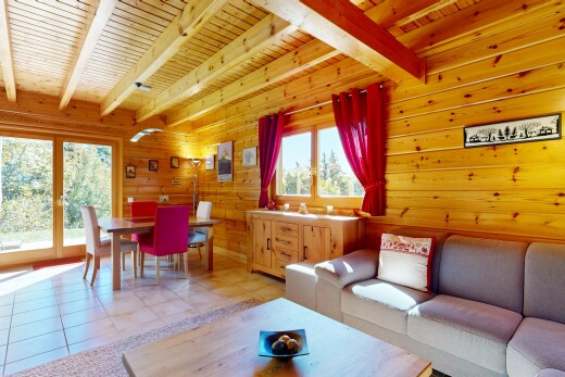 living area featuring a wood ceiling with exposed beams, wooden walls, light tile patterned floors, and access to exterior