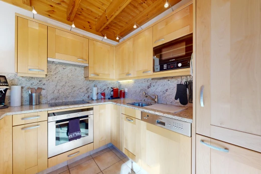 kitchen featuring light wood finish cabinets, black appliances, light stone counters, light tile patterned floors, and a wood ceiling with exposed beams