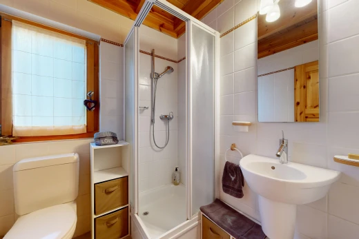 full bath with a shower stall and tile walls