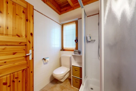 full bathroom featuring a stall shower, light tile patterned floors, and tile walls