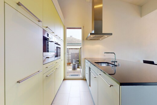 kitchen with sink, refrigerator, light tile patterned flooring, and extractor fan
