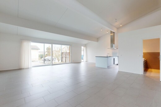 empty room featuring lofted ceiling with beams