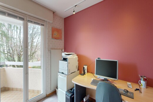 office with wallpapered walls and rail lighting