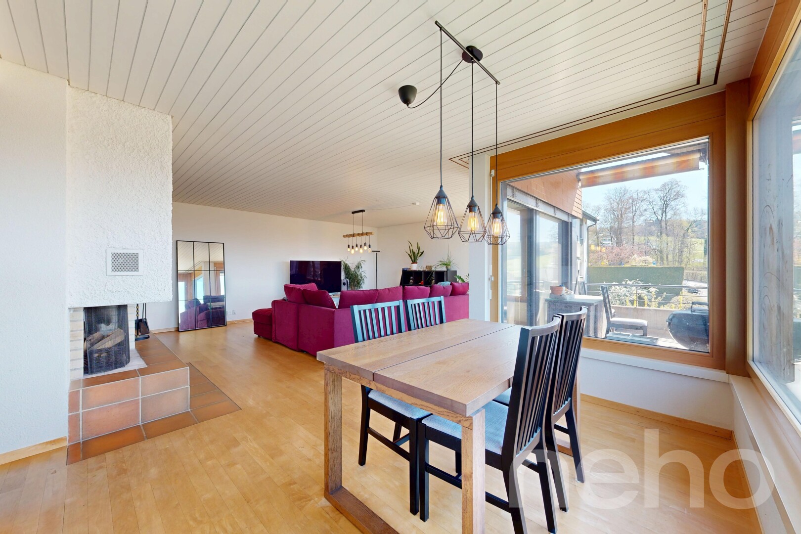 living / dining area featuring wooden ceiling, light wood-type flooring, a multi sided fireplace, and hanging lights