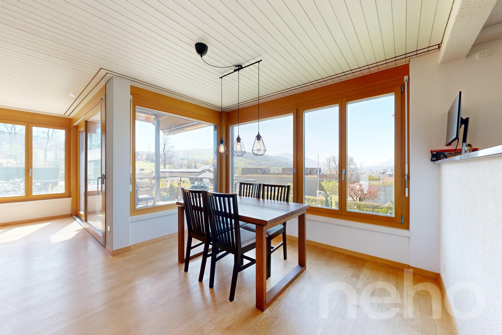 dining room with healthy amount of natural light, light wood-style floors, and wood ceiling
