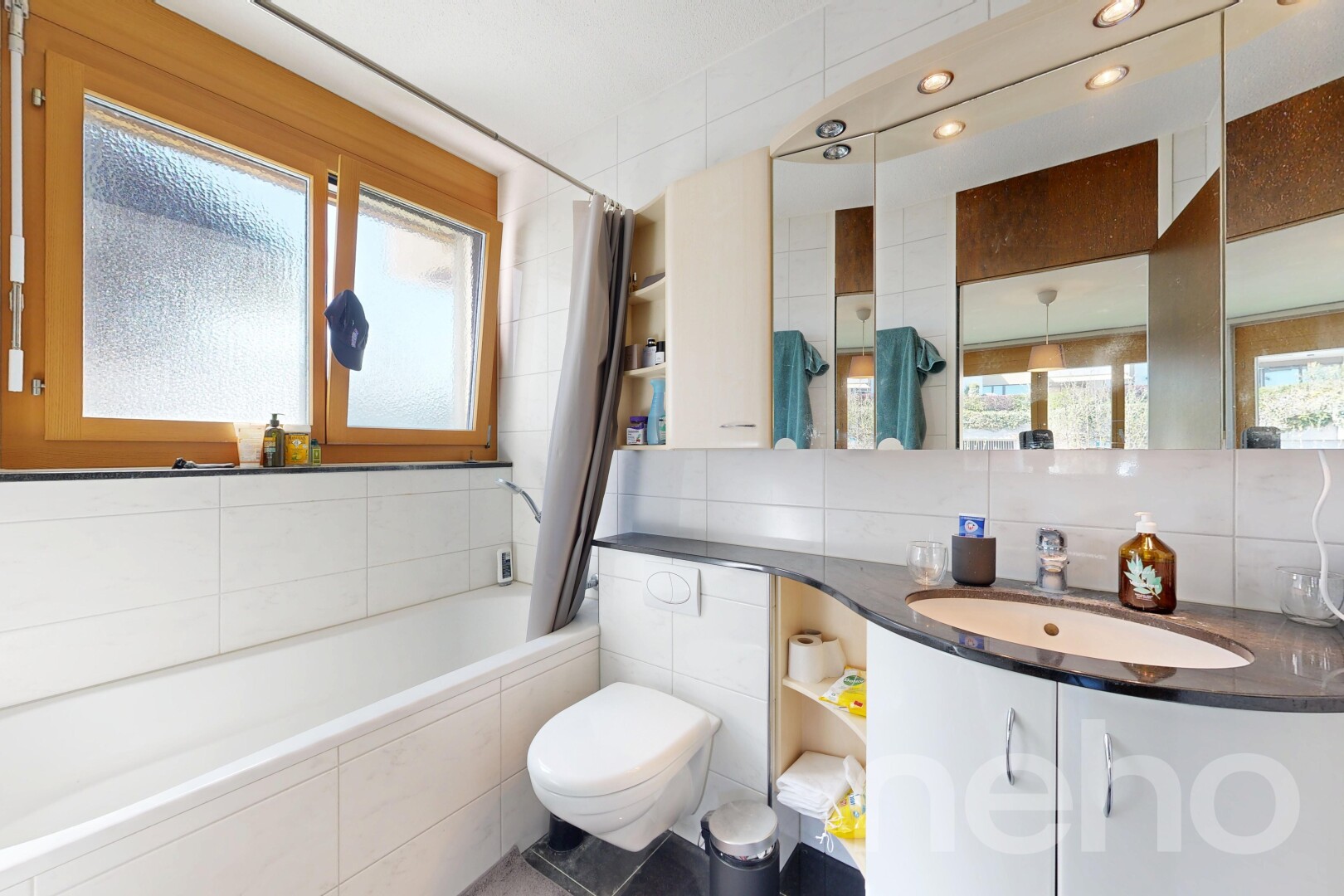 bathroom with vanity, a relaxing tiled tub, tile walls, plenty of natural light, and a shower with curtain