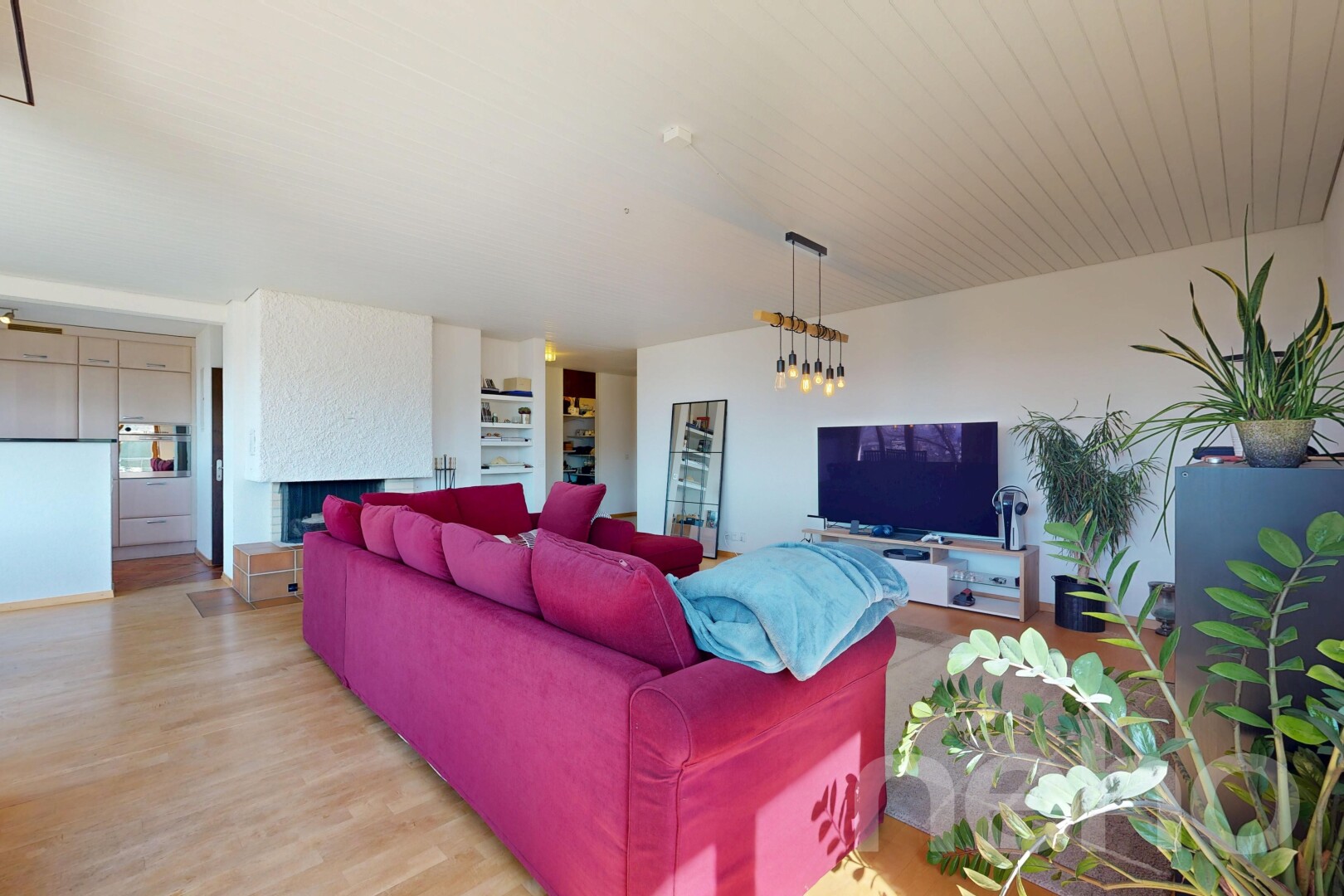 living room featuring wood finished floors and a large fireplace