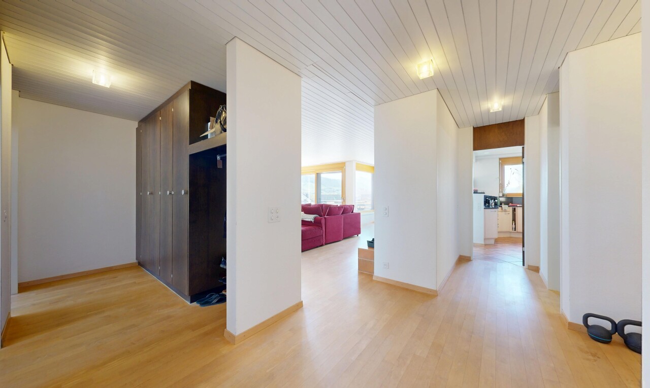 hall featuring light wood-type flooring, wood ceiling, and healthy amount of natural light