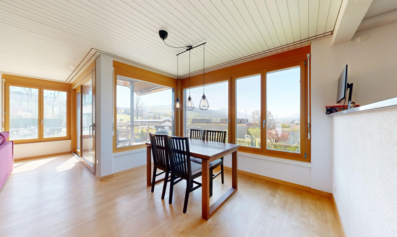 dining room with healthy amount of natural light, light wood-style floors, and wood ceiling