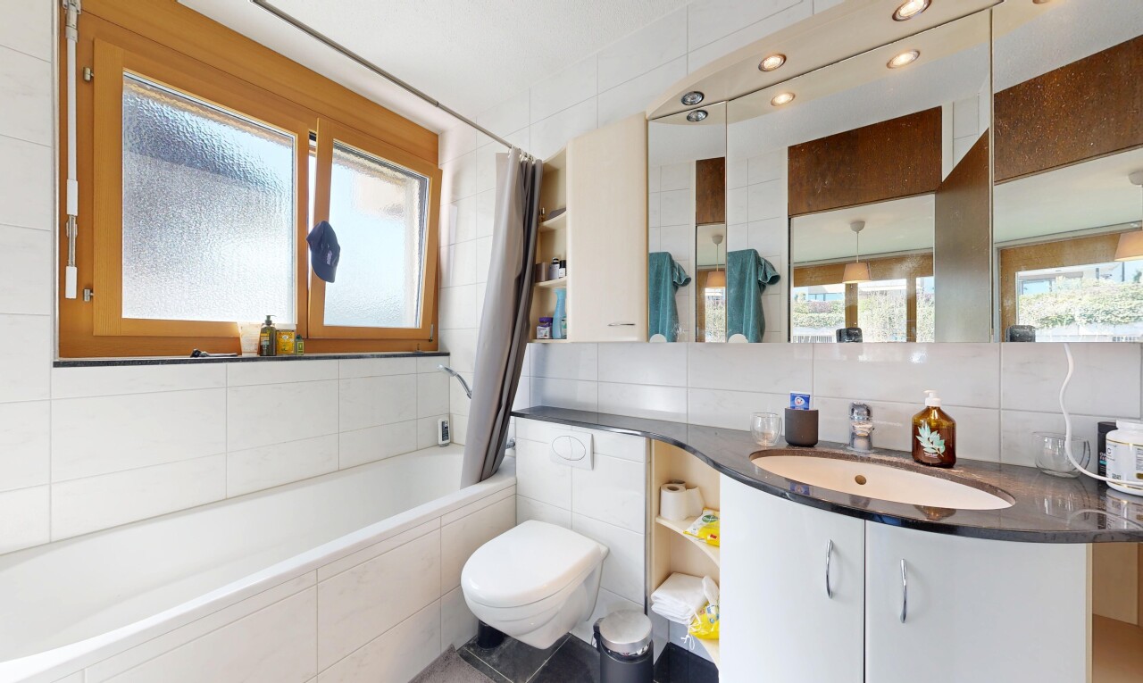 bathroom with vanity, a relaxing tiled tub, tile walls, plenty of natural light, and a shower with curtain