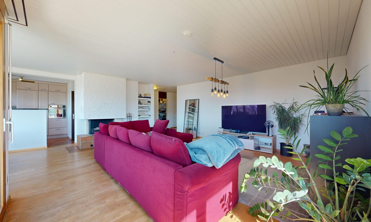 living room featuring wood finished floors and a large fireplace