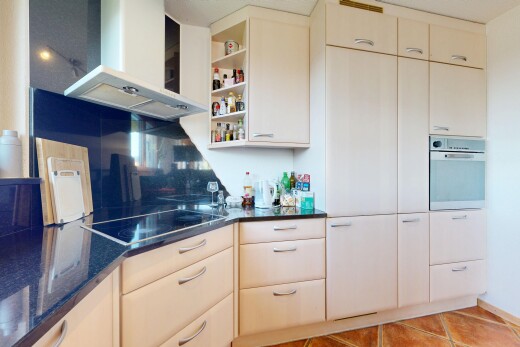 cuisine avec hotte, dark countertops, four, open shelves, et étagères ouvertes