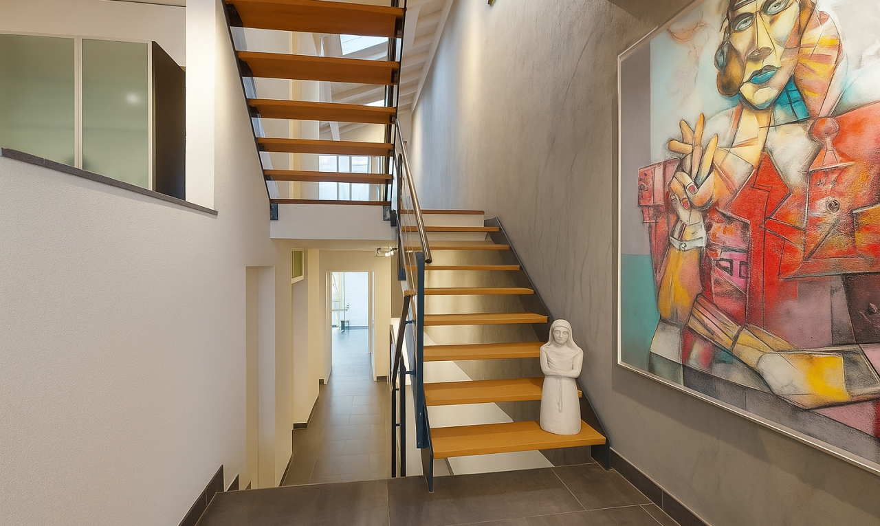 stairway featuring a towering ceiling