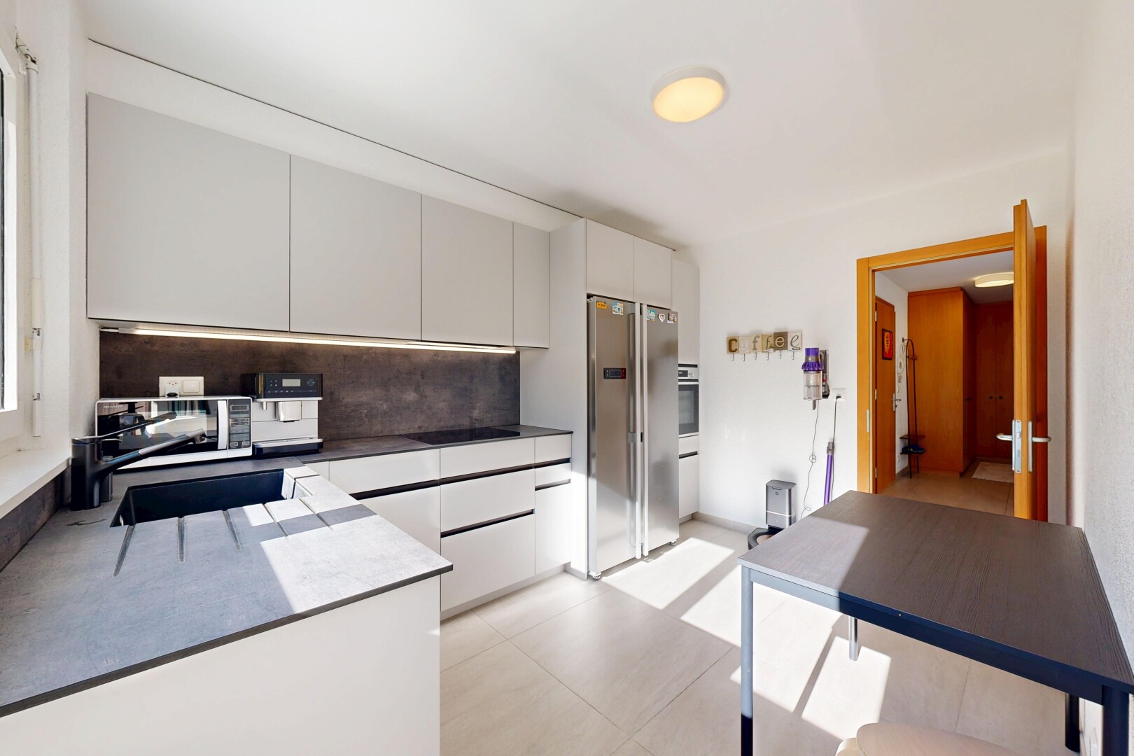 kitchen with appliances with stainless steel finishes, backsplash, modern cabinets, and dark countertops