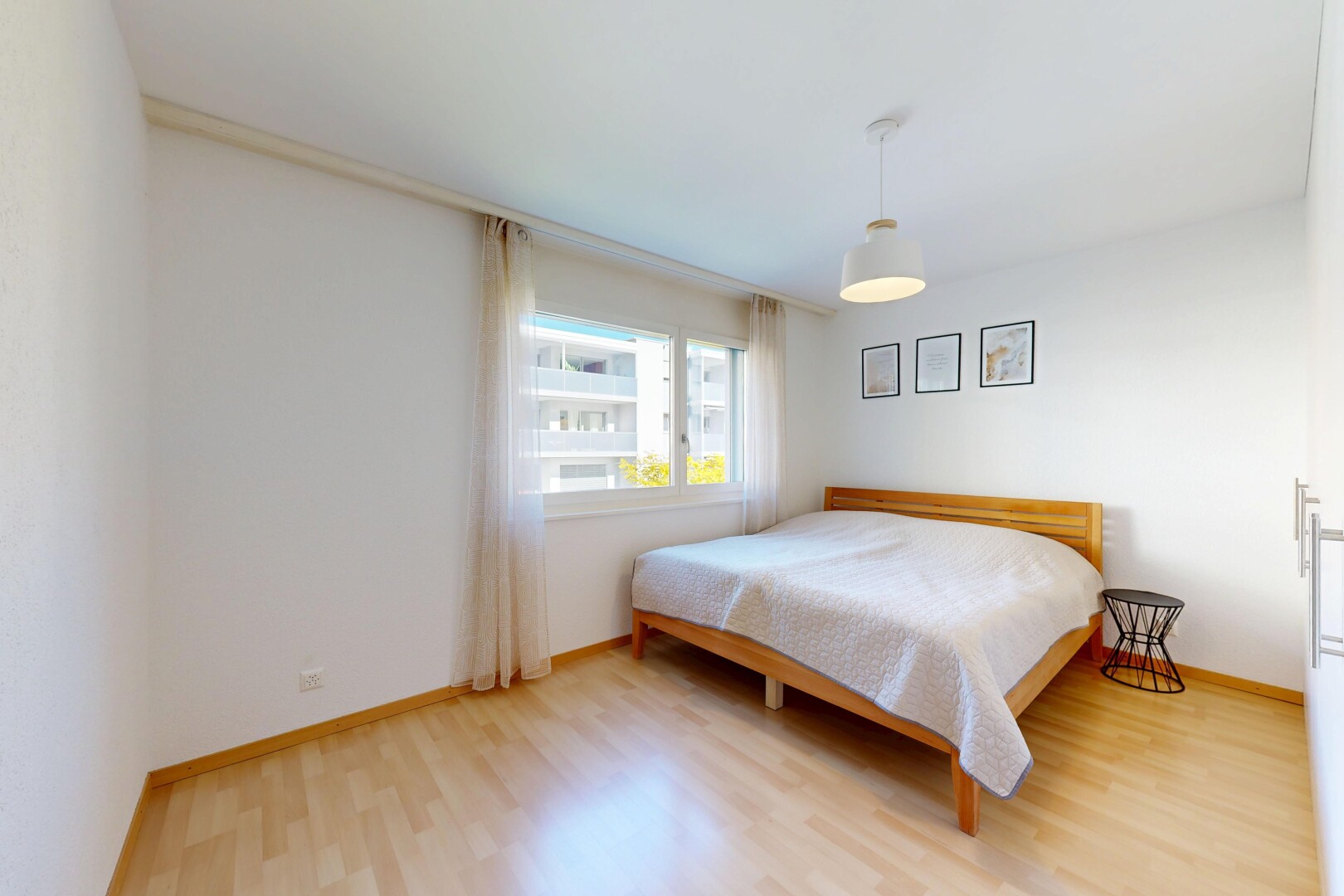 room / bedroom featuring light wood finished floors and baseboards