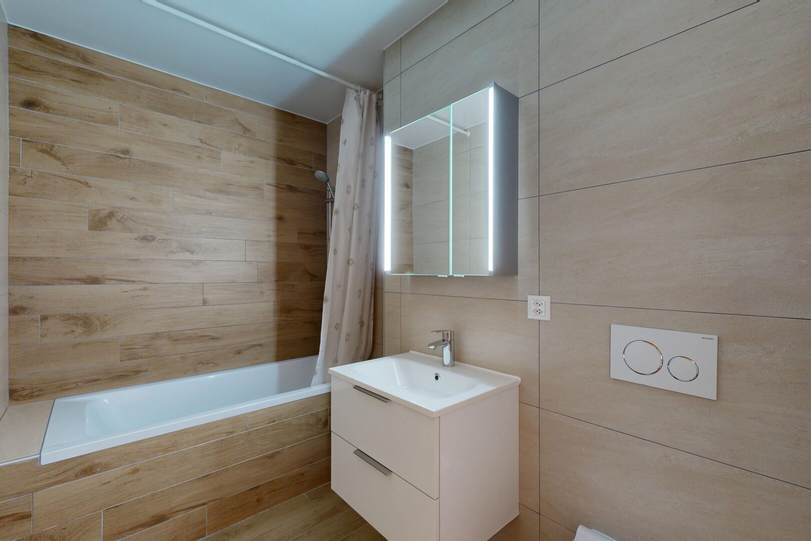 full bathroom featuring tiled shower / bath, vanity, and tile walls