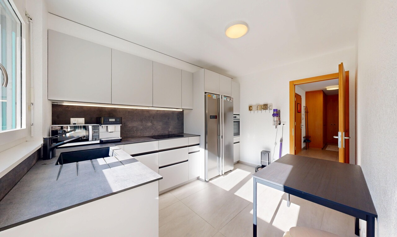 kitchen with appliances with stainless steel finishes, backsplash, modern cabinets, and dark countertops